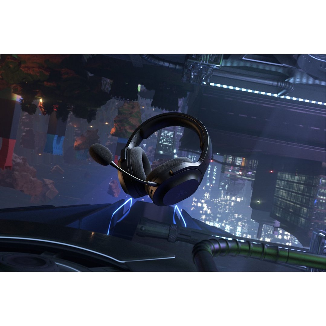 Black wireless headset with microphone floating above a futuristic city at night