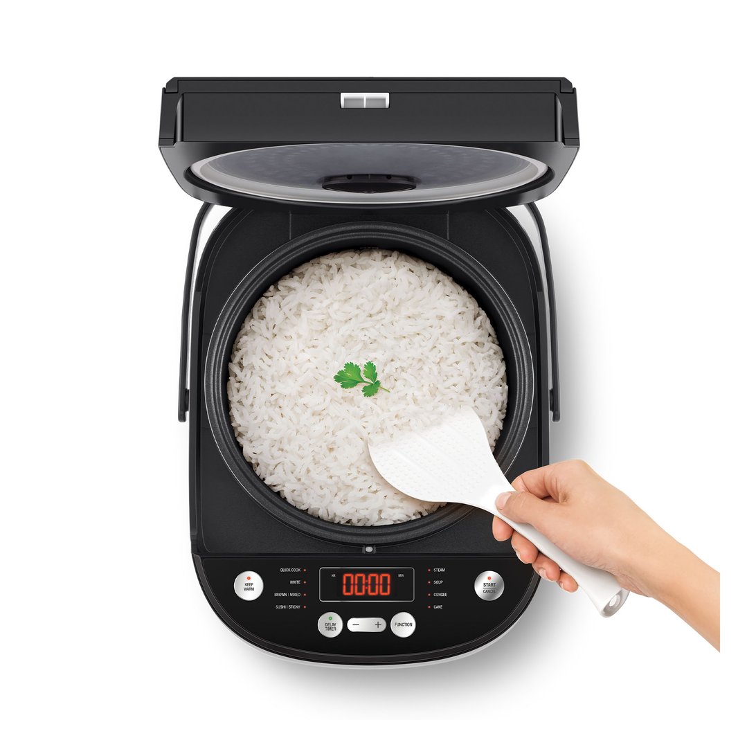 Overhead view of a hand serving rice from a black rice cooker