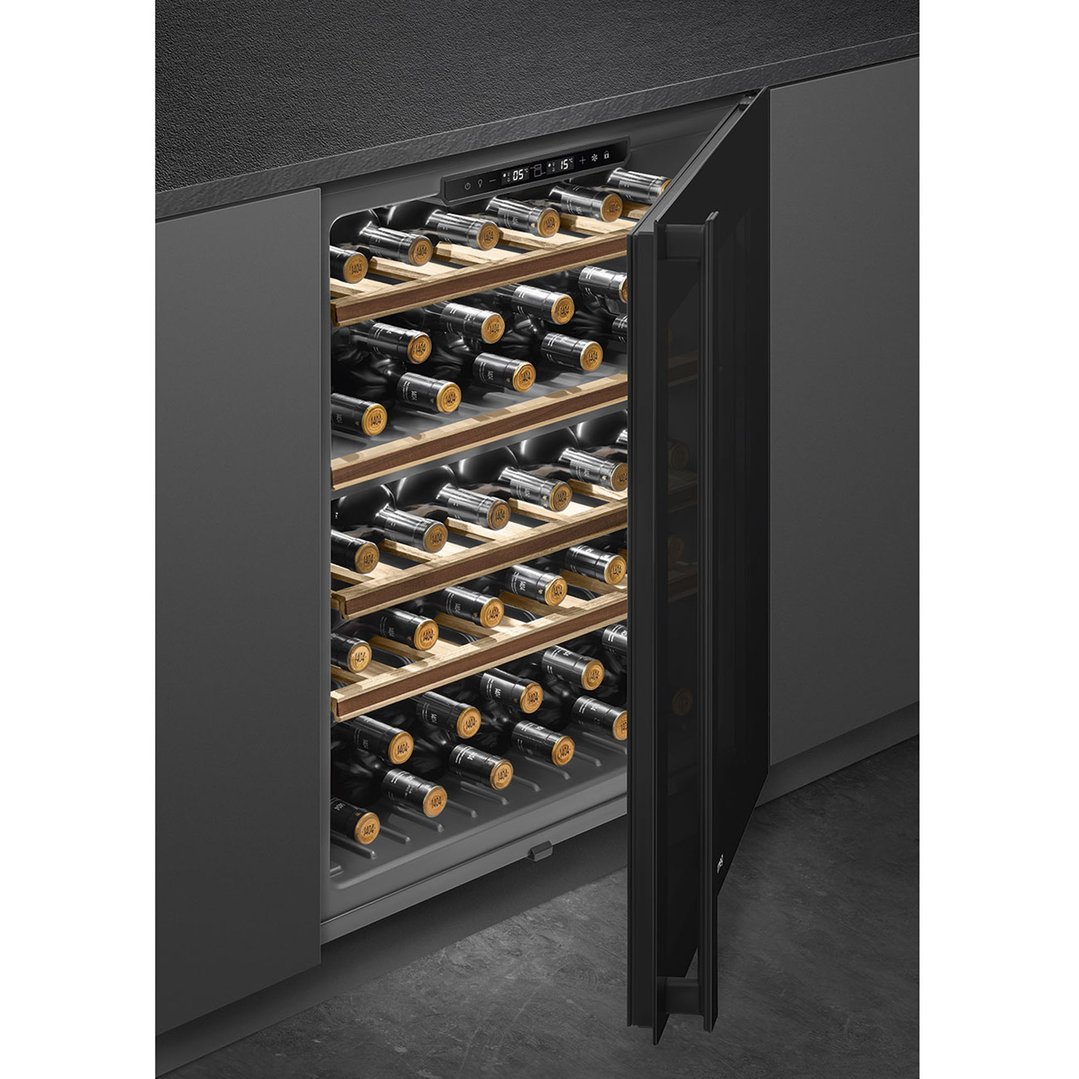 Built-in wine cooler with open door showing wine bottles on wooden shelves