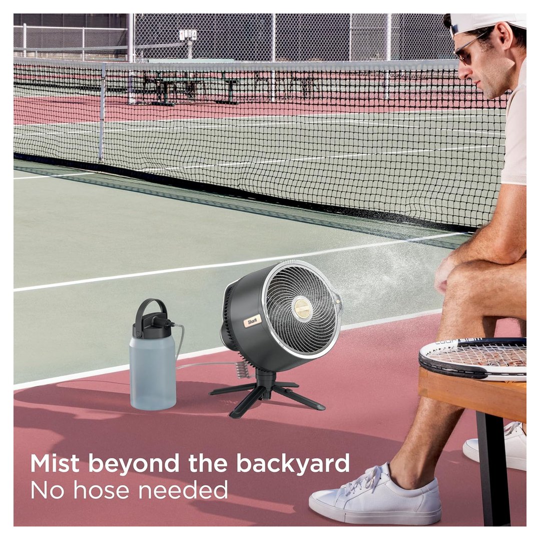 A man sitting on a tennis court with a Shark FlexBreeze Pro Mist fan