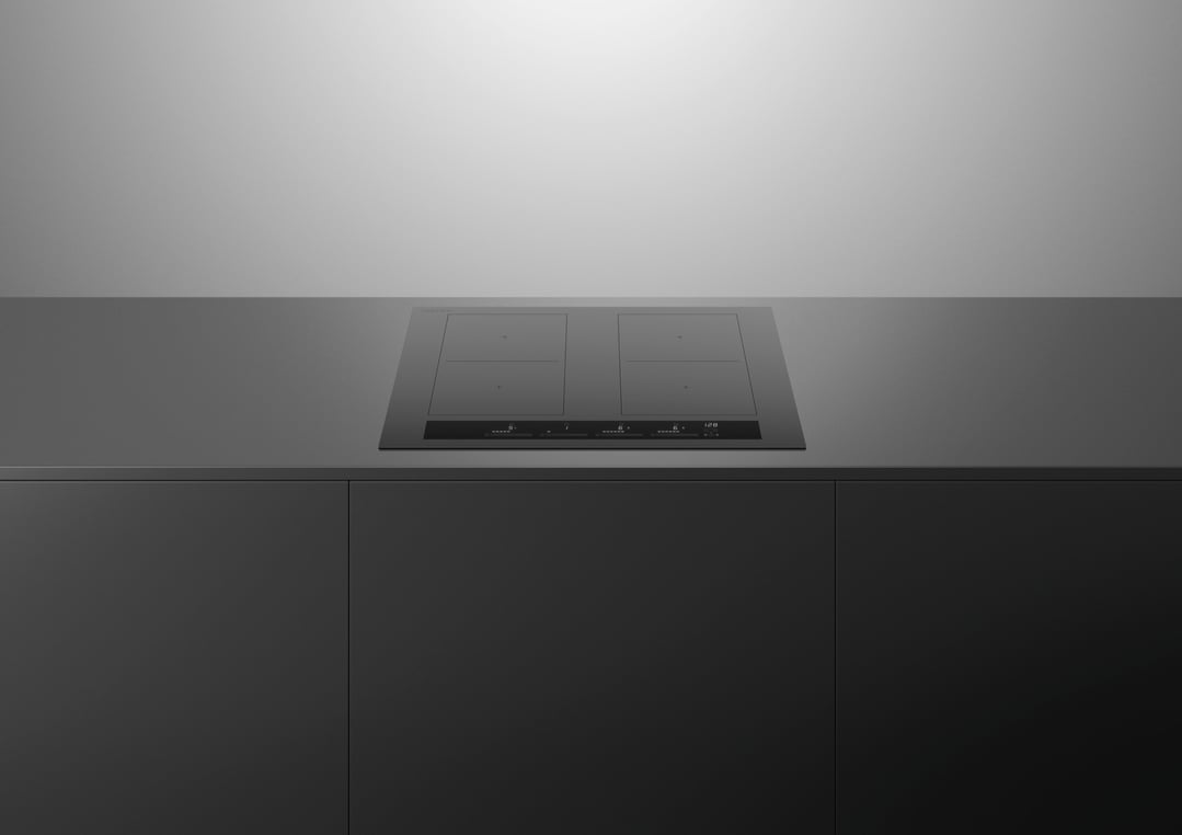 Grey induction cooktop built into a dark grey kitchen countertop