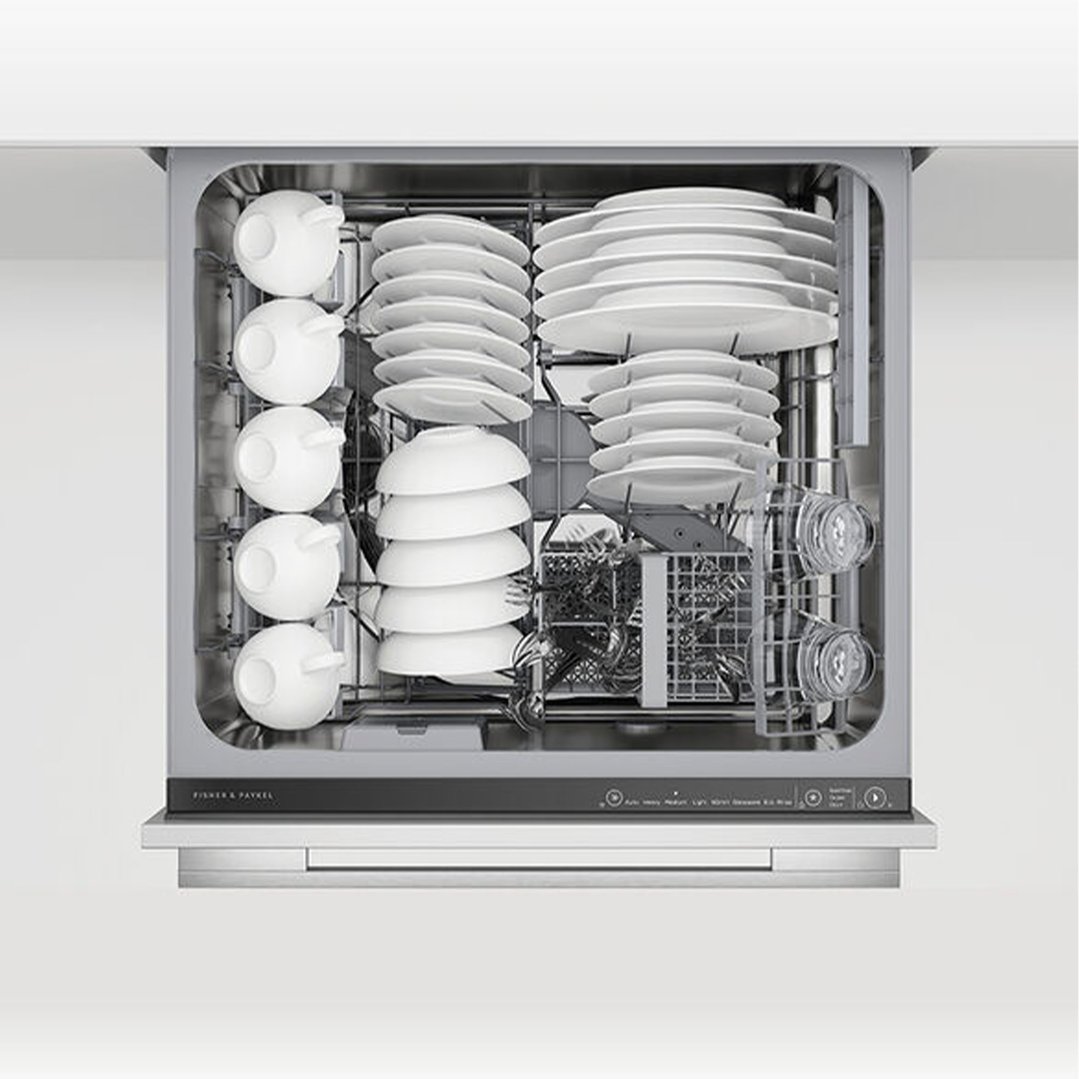 Open DishDrawer dishwasher filled with white dishes, cups, and glasses