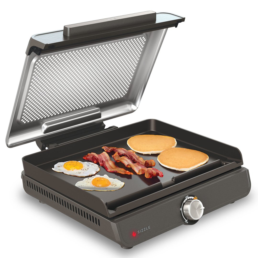 Ninja Sizzle Indoor Grill and Flat Plate cooking eggs, bacon, and pancakes