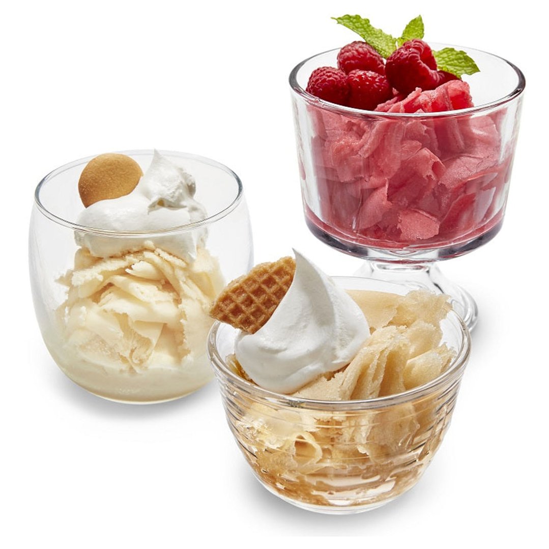 Three glasses of shave ice desserts with various toppings on a white background