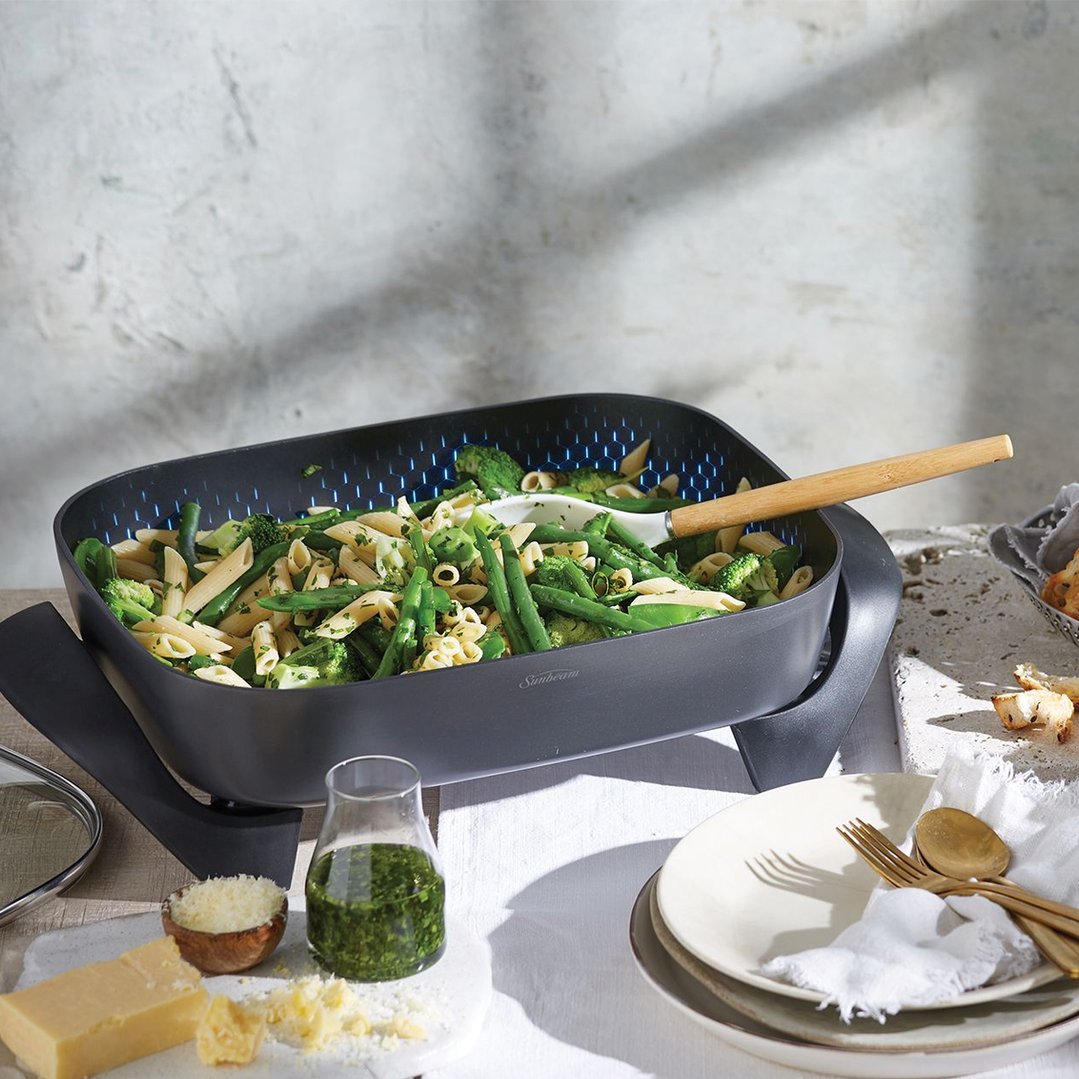 Sunbeam electric frypan filled with pasta and vegetables on a styled table
