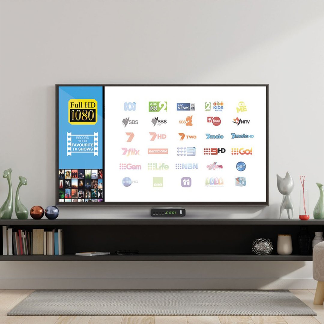 Digital Set Top Box under a TV displaying channels in a living room