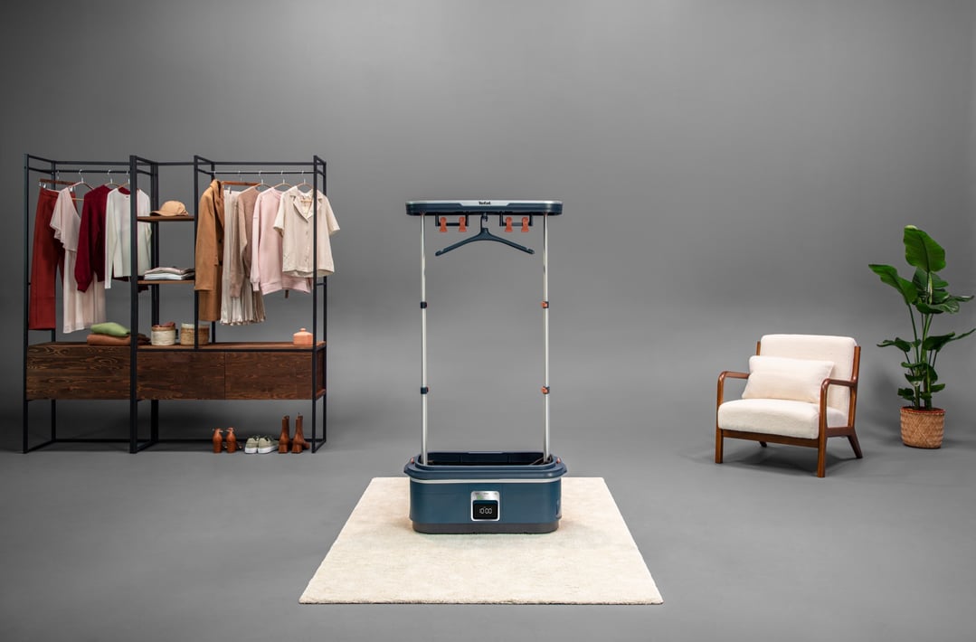 Tefal automatic garment steamer in a room with a clothes rack and armchair