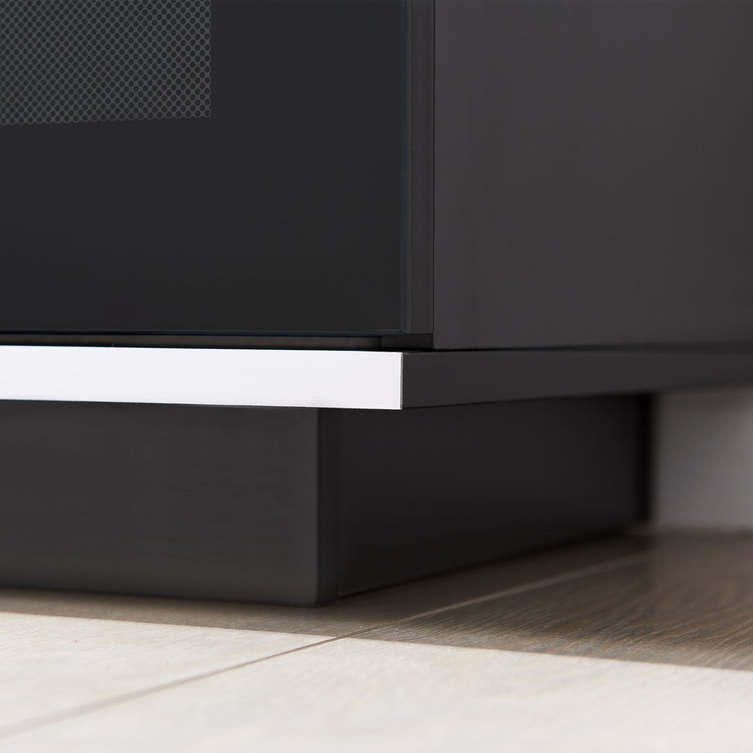 Close up of the base of a black TV cabinet on a wooden floor
