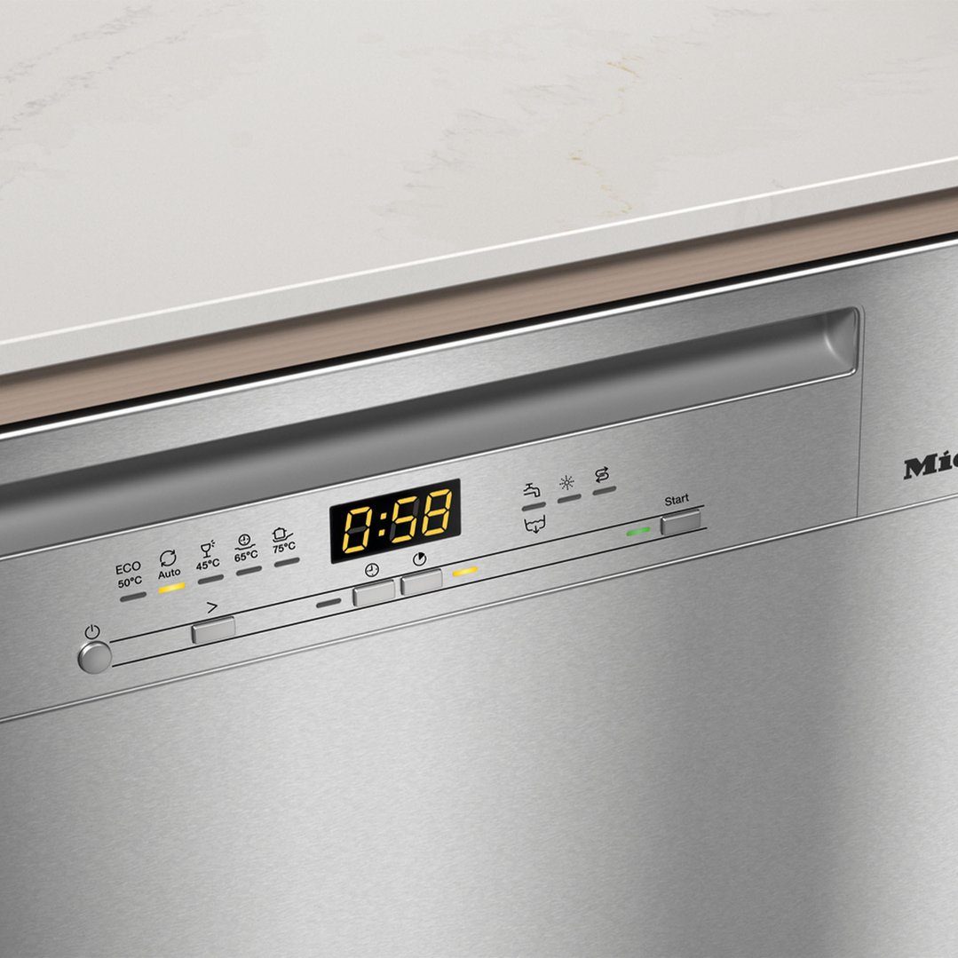 Close up of a Miele dishwasher control panel with a digital display