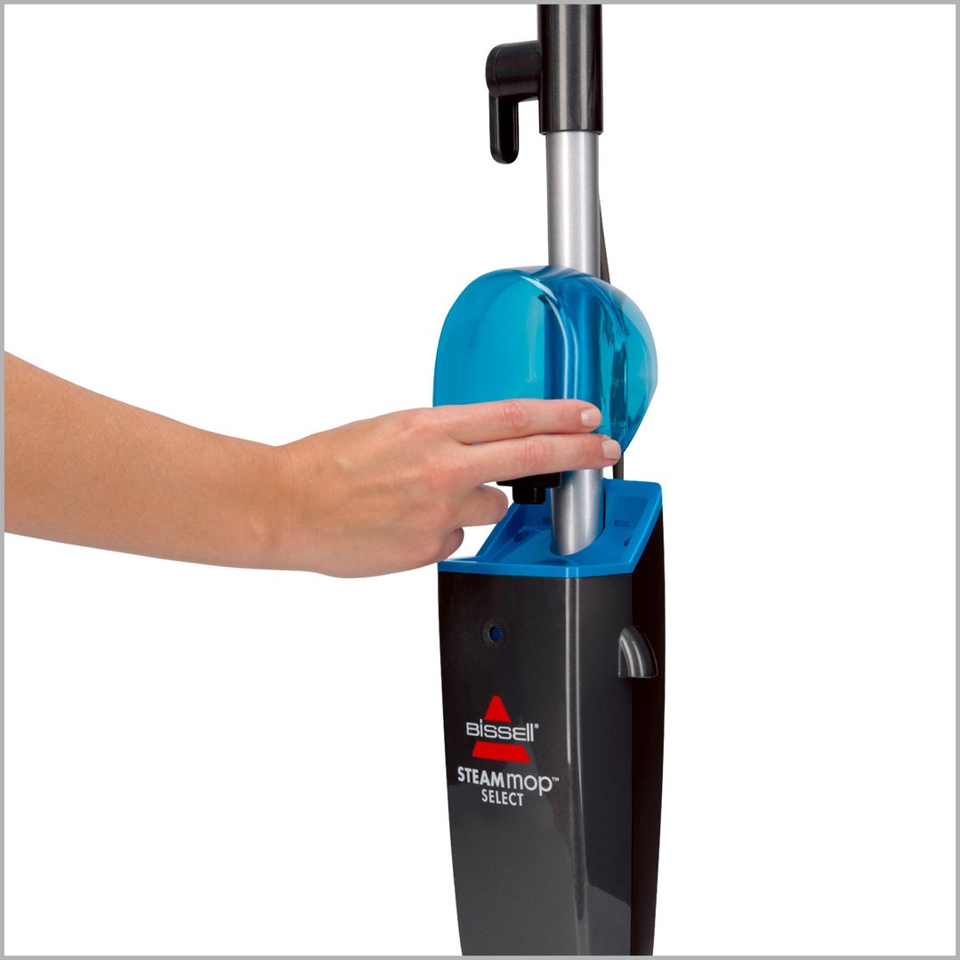 Hand inserting the water tank into the Bissell Steam Mop Select
