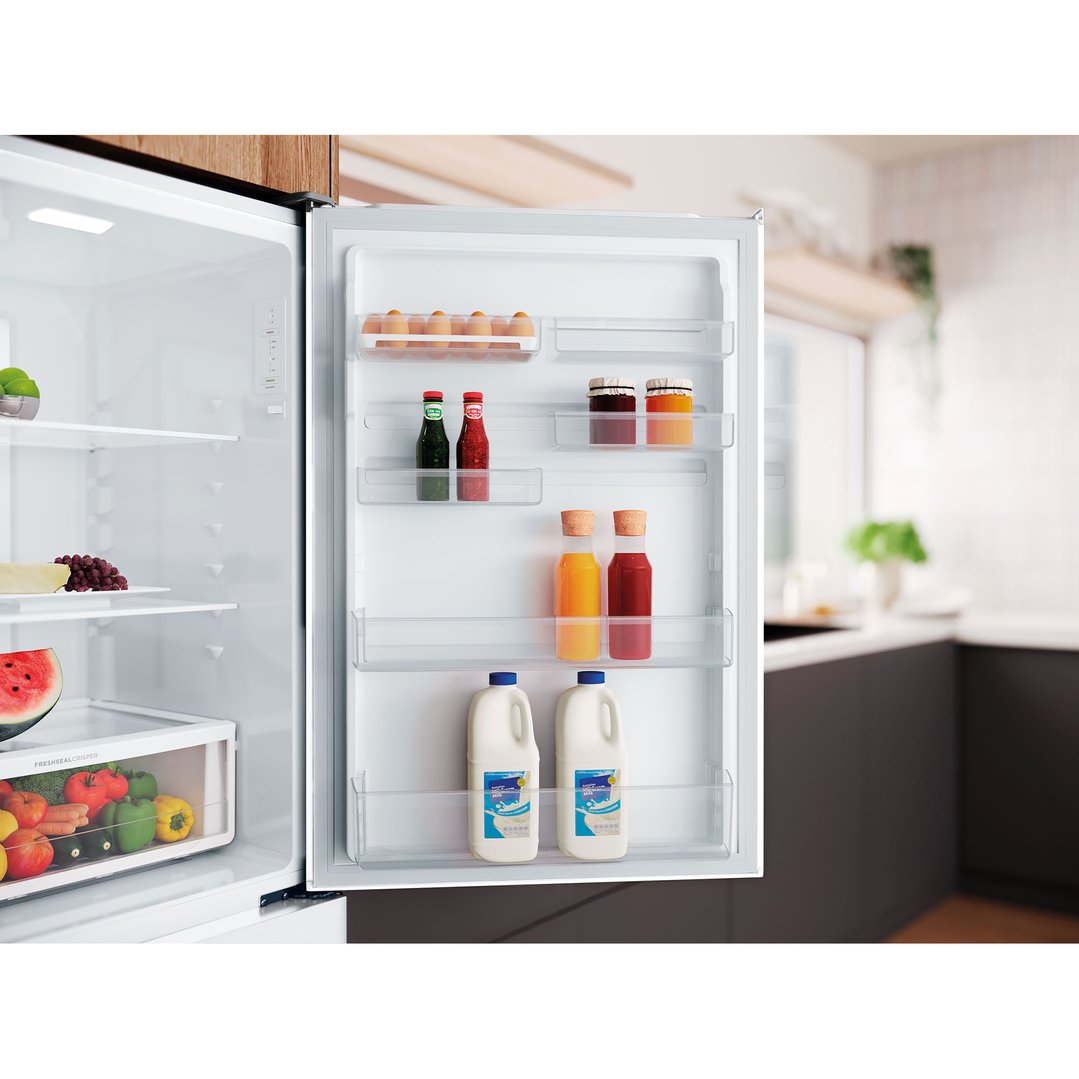 Open Westinghouse bottom mount fridge in a kitchen with food inside