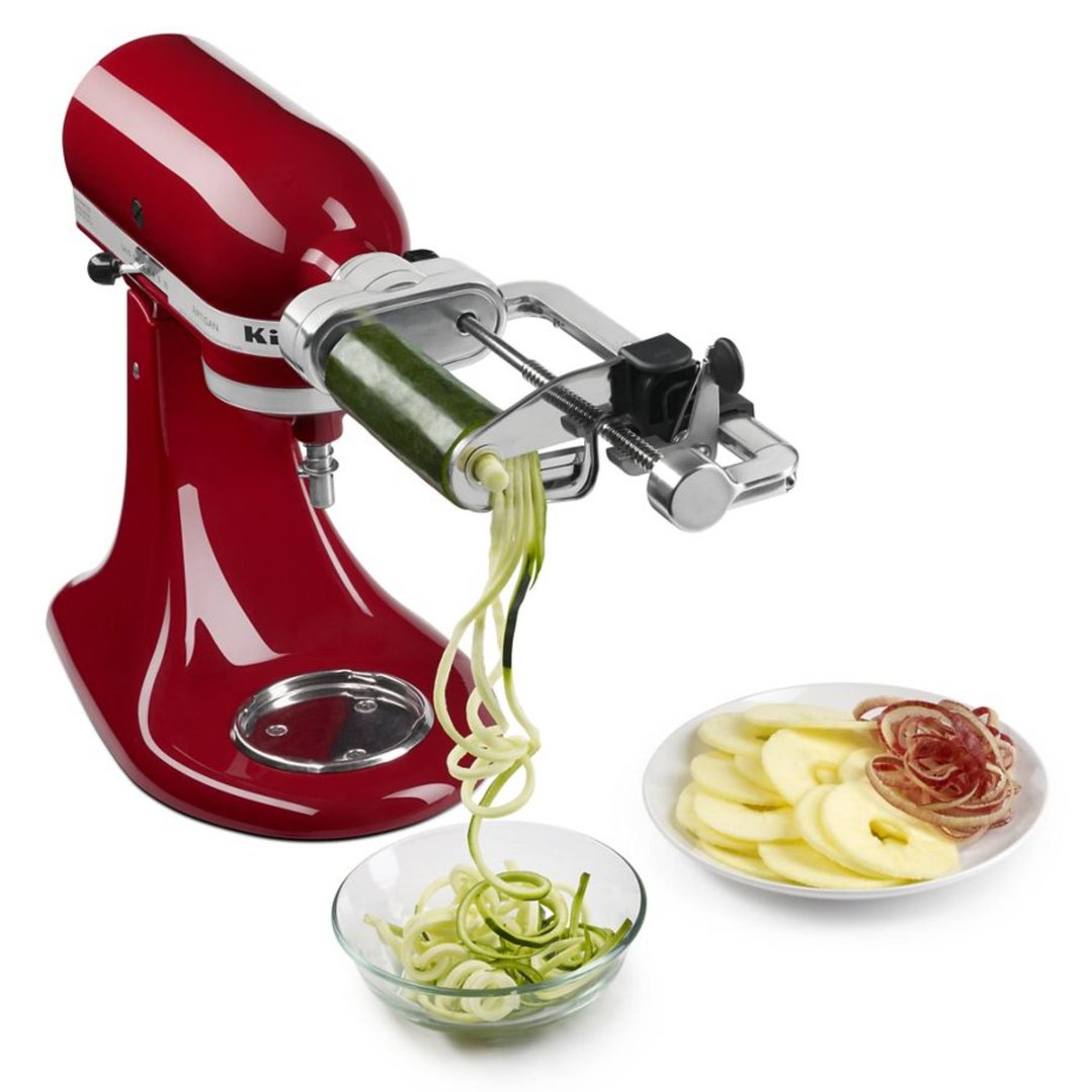 Red KitchenAid stand mixer with spiralizer attachment making zucchini noodles