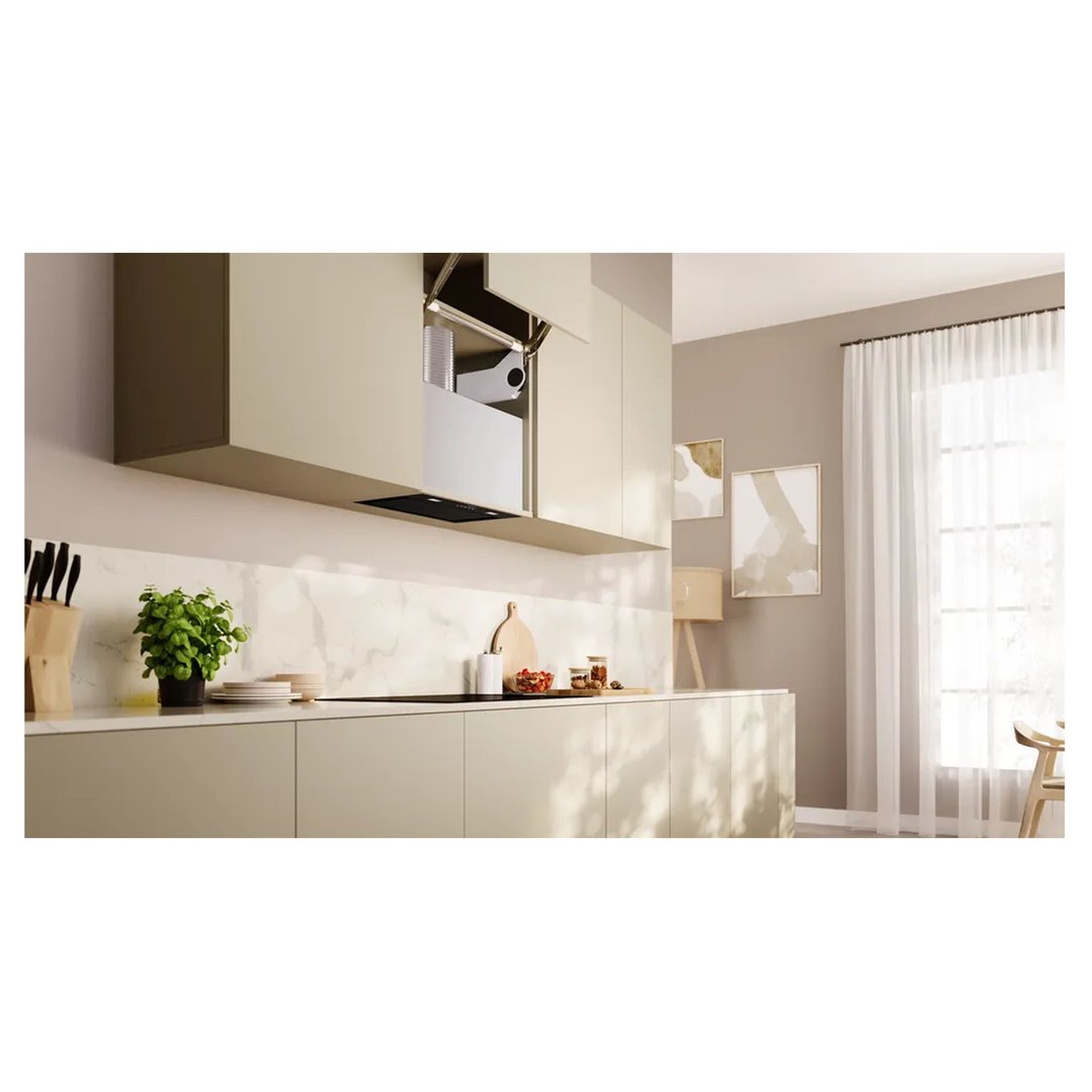 Integrated rangehood in a modern kitchen with light cabinetry and marble backsplash