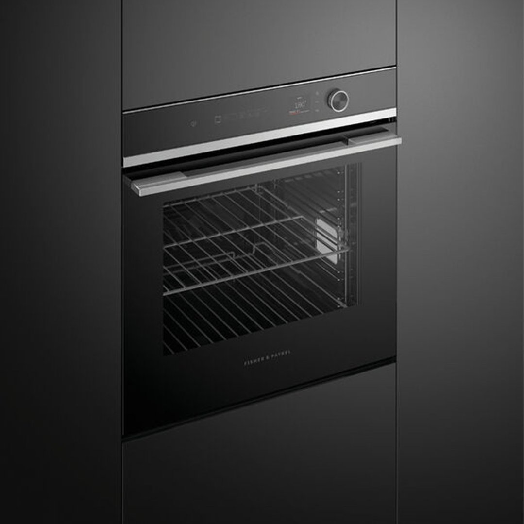 Black built-in oven with a stainless steel handle and control panel