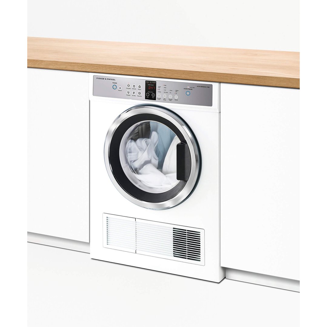 White vented dryer built into a kitchen counter with a wooden top