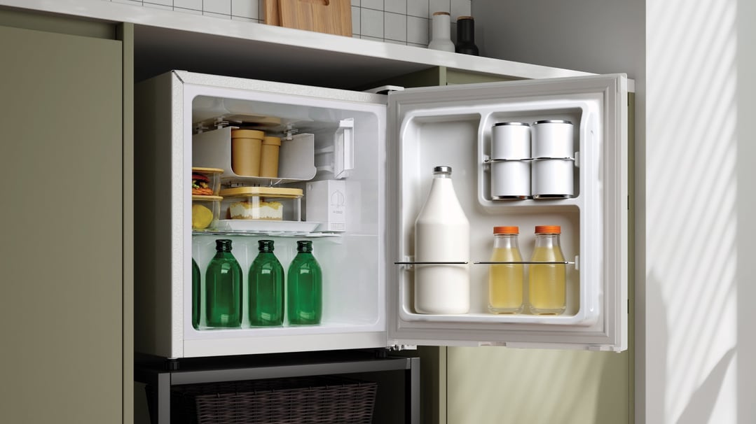Open bar refrigerator filled with drinks and food in a kitchen setting