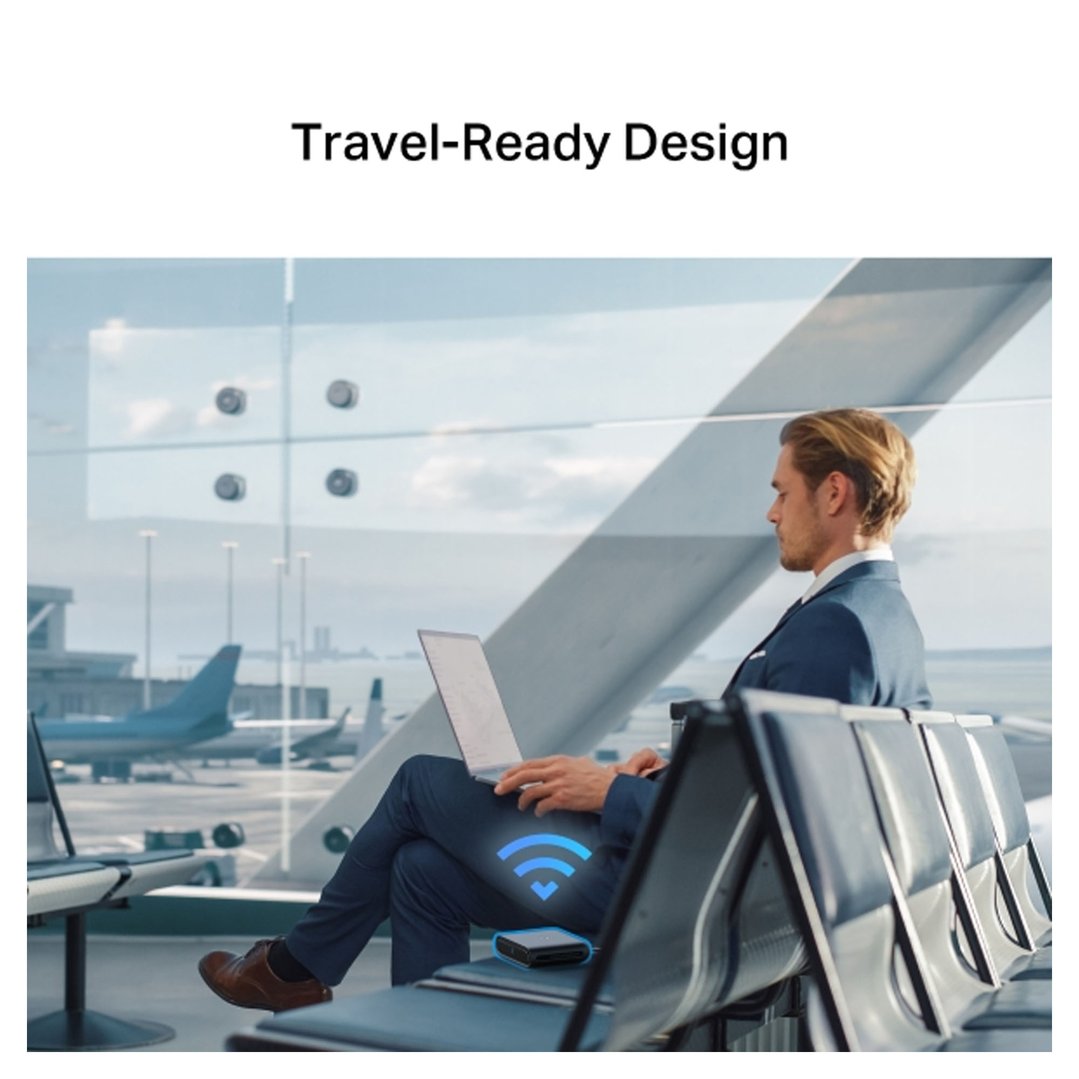 Man using a laptop with a Wi-Fi 6 router in an airport lounge