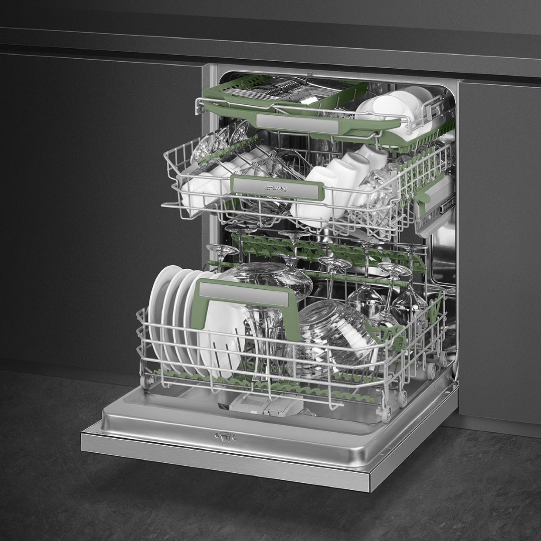 Open dishwasher with dishes and glasses on racks in a dark kitchen