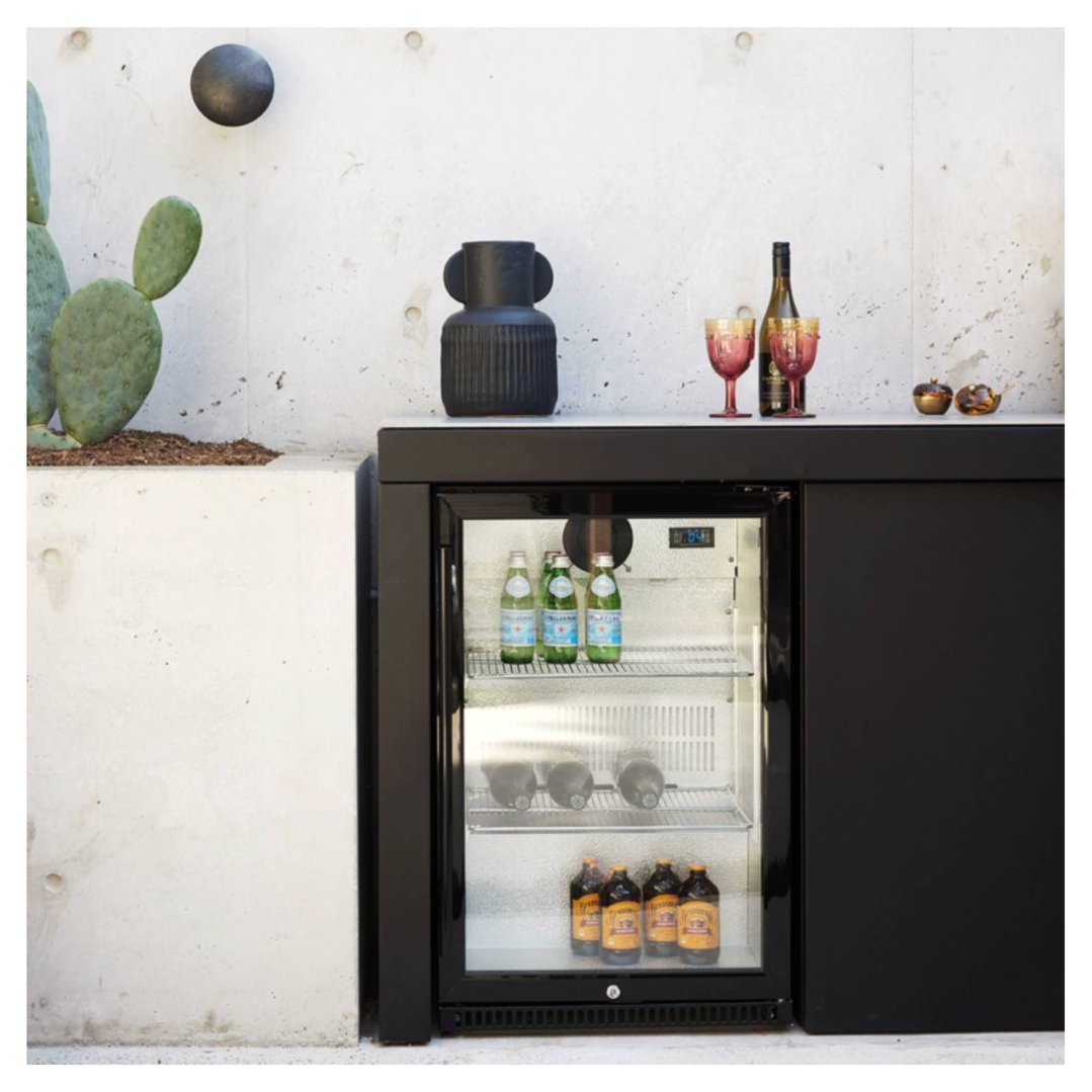 Outdoor beverage chiller with drinks inside, styled with cactus and decor