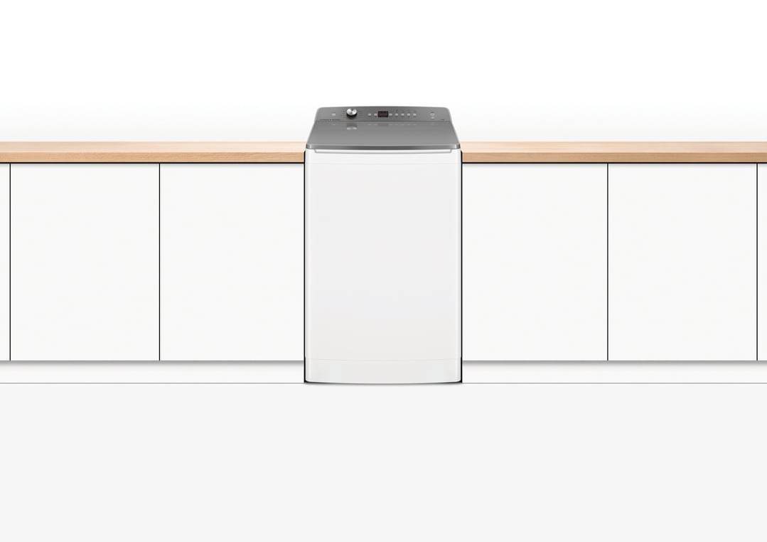 White top loader washing machine integrated into a kitchen counter setting