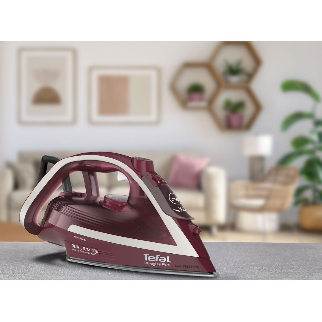 Tefal Ultragliss Anti-Calc Plus steam iron on an ironing board in a living room
