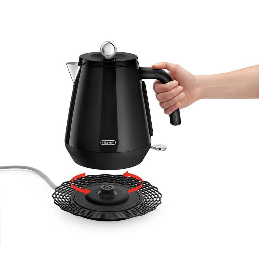 Hand placing black kettle onto its 360-degree swivel base