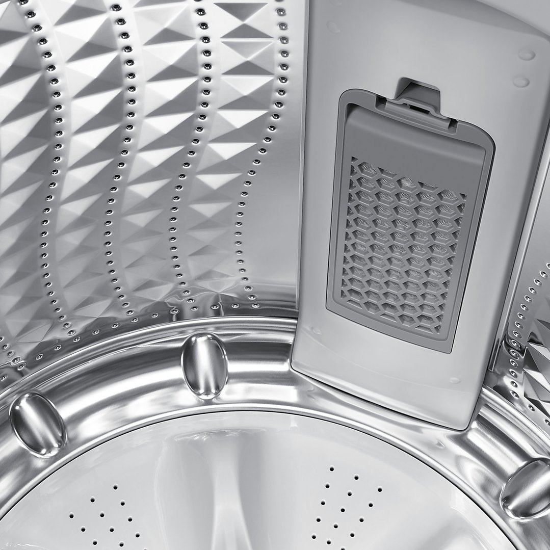 Close-up inside a top load washing machine drum with a lint filter