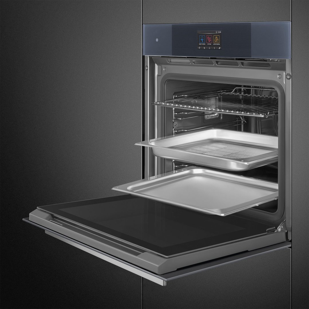 Built-in oven with door open, showing interior racks and baking trays