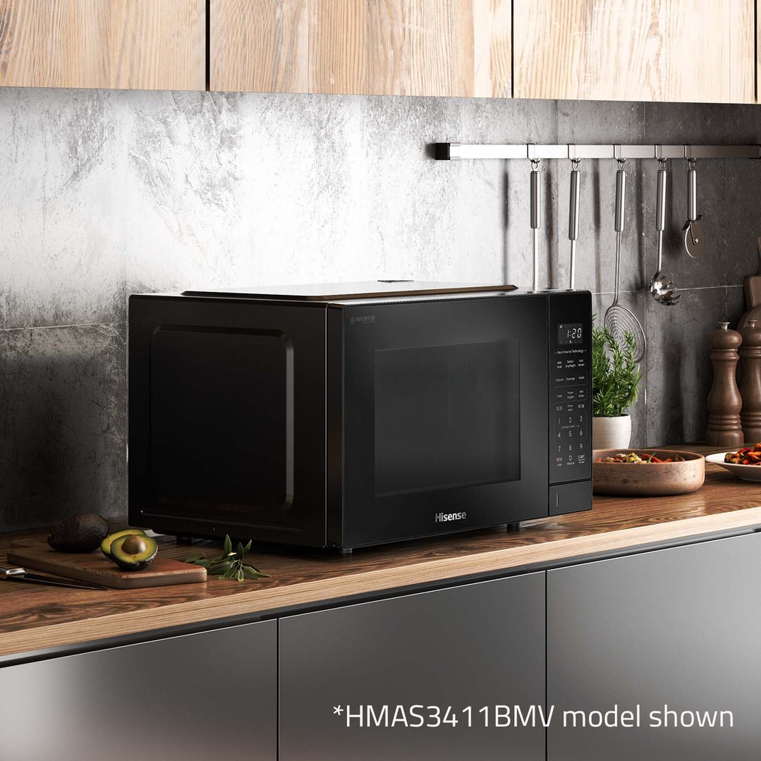 Black microwave on a wooden countertop in a modern kitchen setting