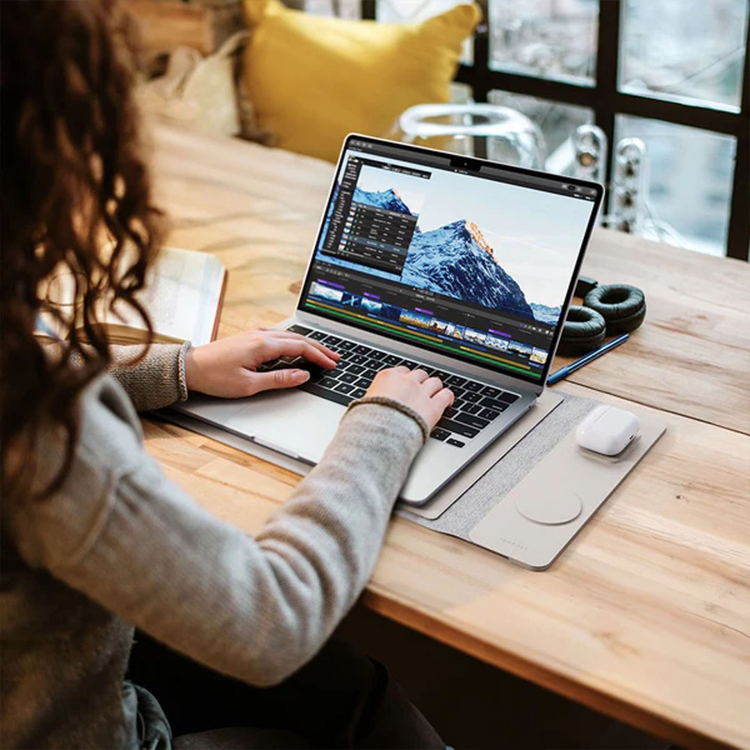 Woman editing video on a laptop with a JOURNEY NEXA laptop sleeve