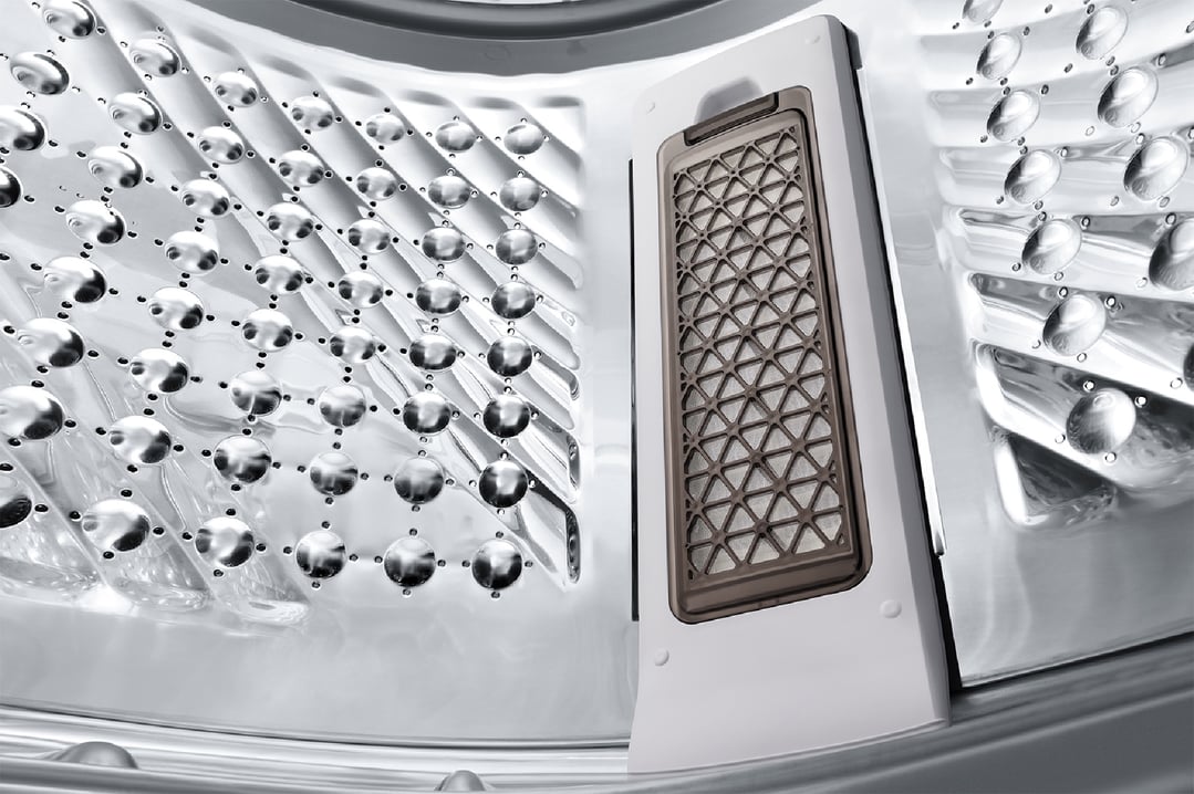 Close-up of the inside of a washing machine drum and lint filter