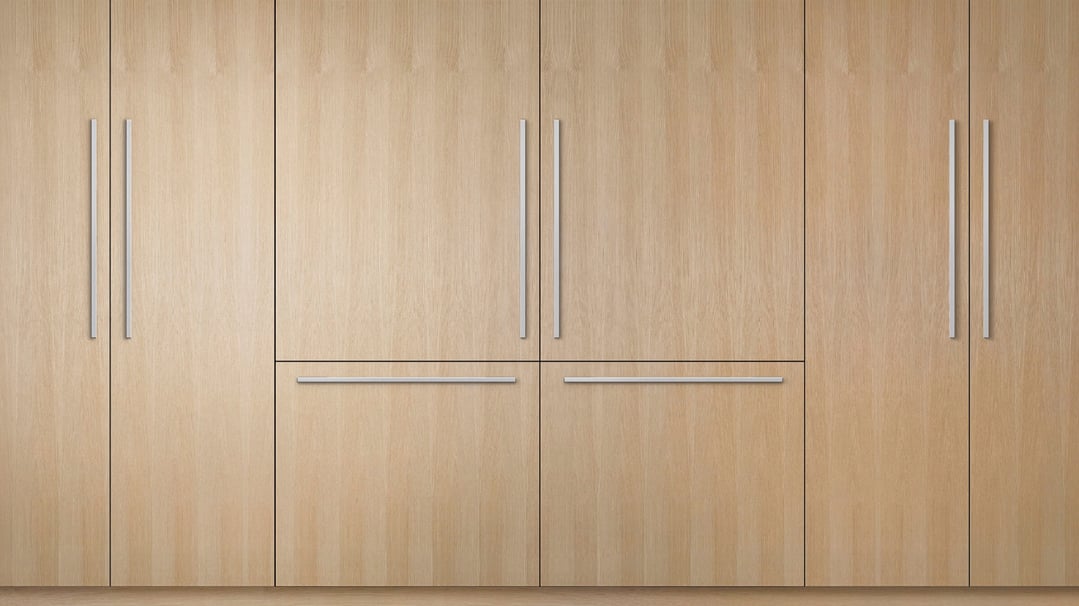 Integrated Refrigerator Freezer with light wood paneling and stainless steel handles
