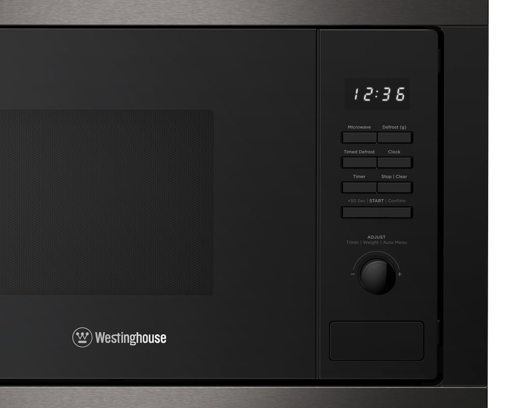 Close-up of a black built-in microwave with digital display and controls