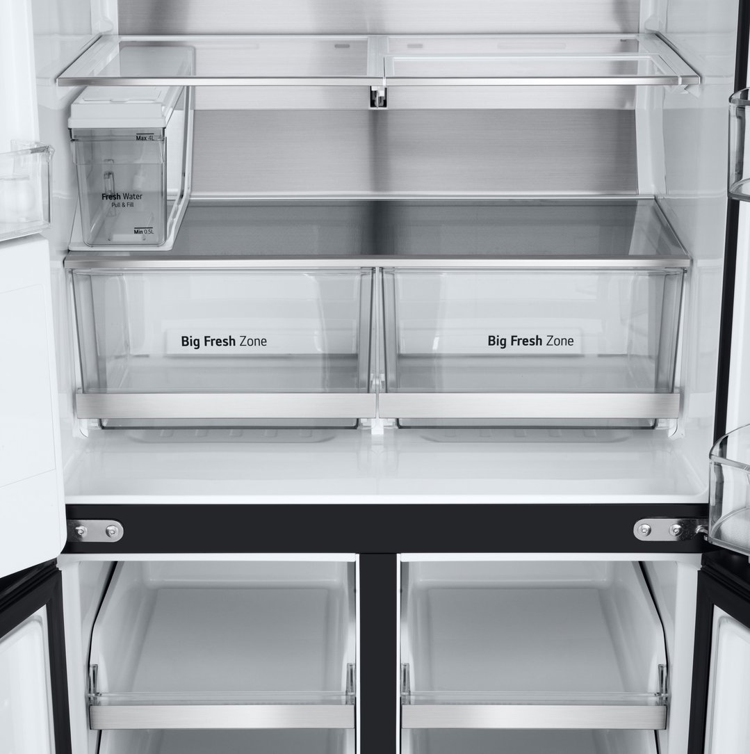 Open French door fridge interior showing water dispenser and crisper drawers