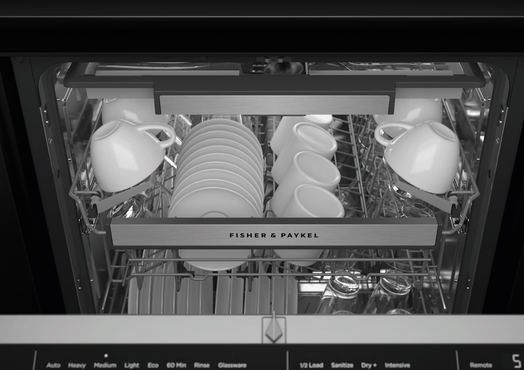 Close up of the interior of a dishwasher filled with white dishes