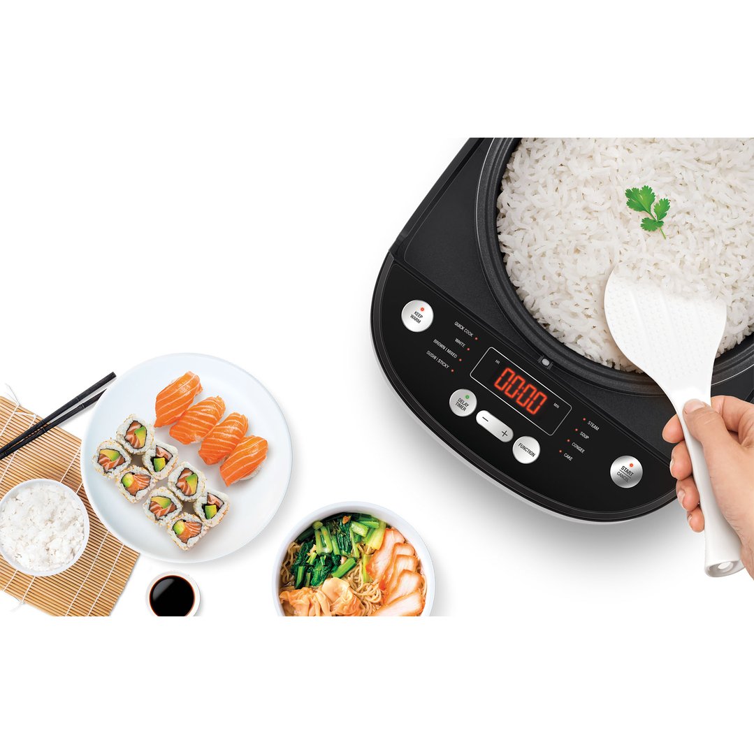 Hand serving cooked rice from a rice cooker, with sushi and noodles