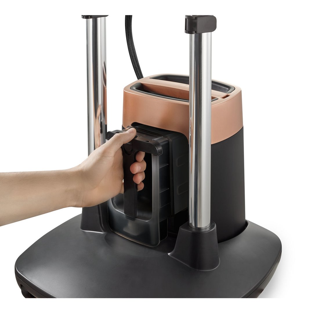 A hand removing the water tank from the garment care solution
