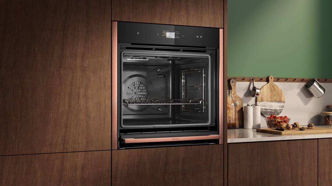 Pyrolytic Slide & Hide Oven with metallic silver trims built into a wooden kitchen