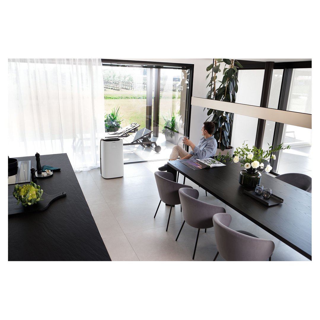 Air conditioner in a modern living space with a person relaxing