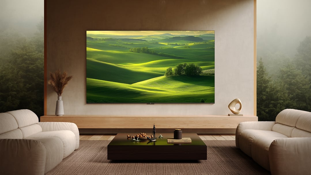 A large TV displaying a green landscape in a modern living room