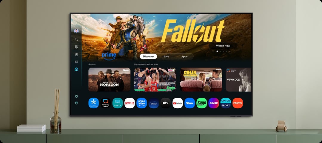 A SAMSUNG TV displaying a smart TV interface on a console in a room