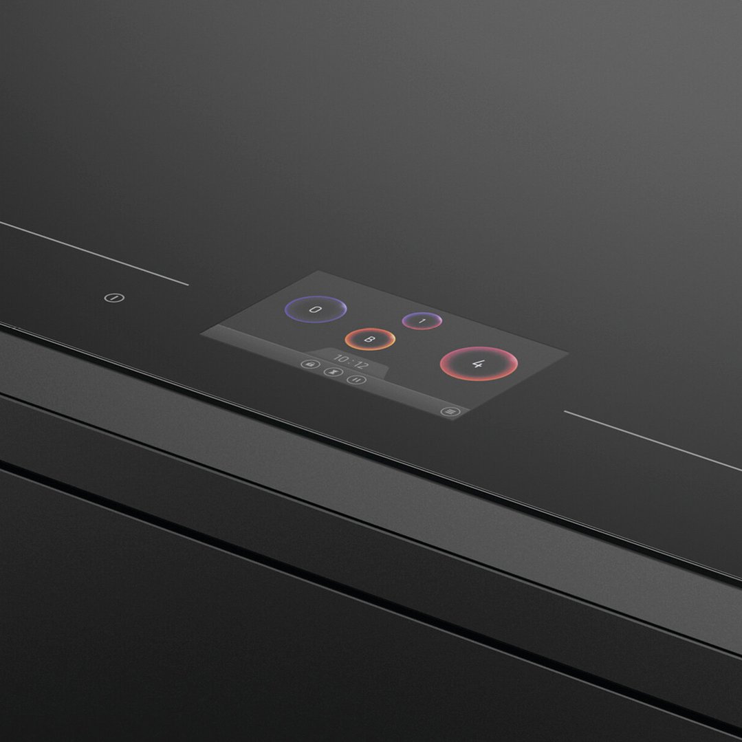 Close up of a black induction cooktop with a digital display showing controls