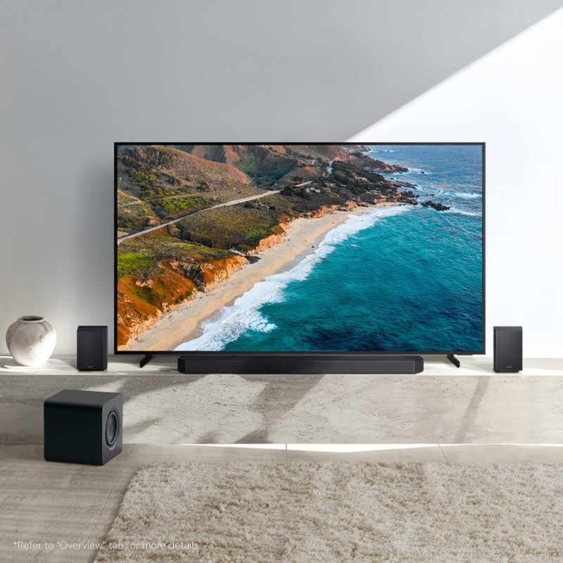 A soundbar, subwoofer, and two rear speakers in a living room setting