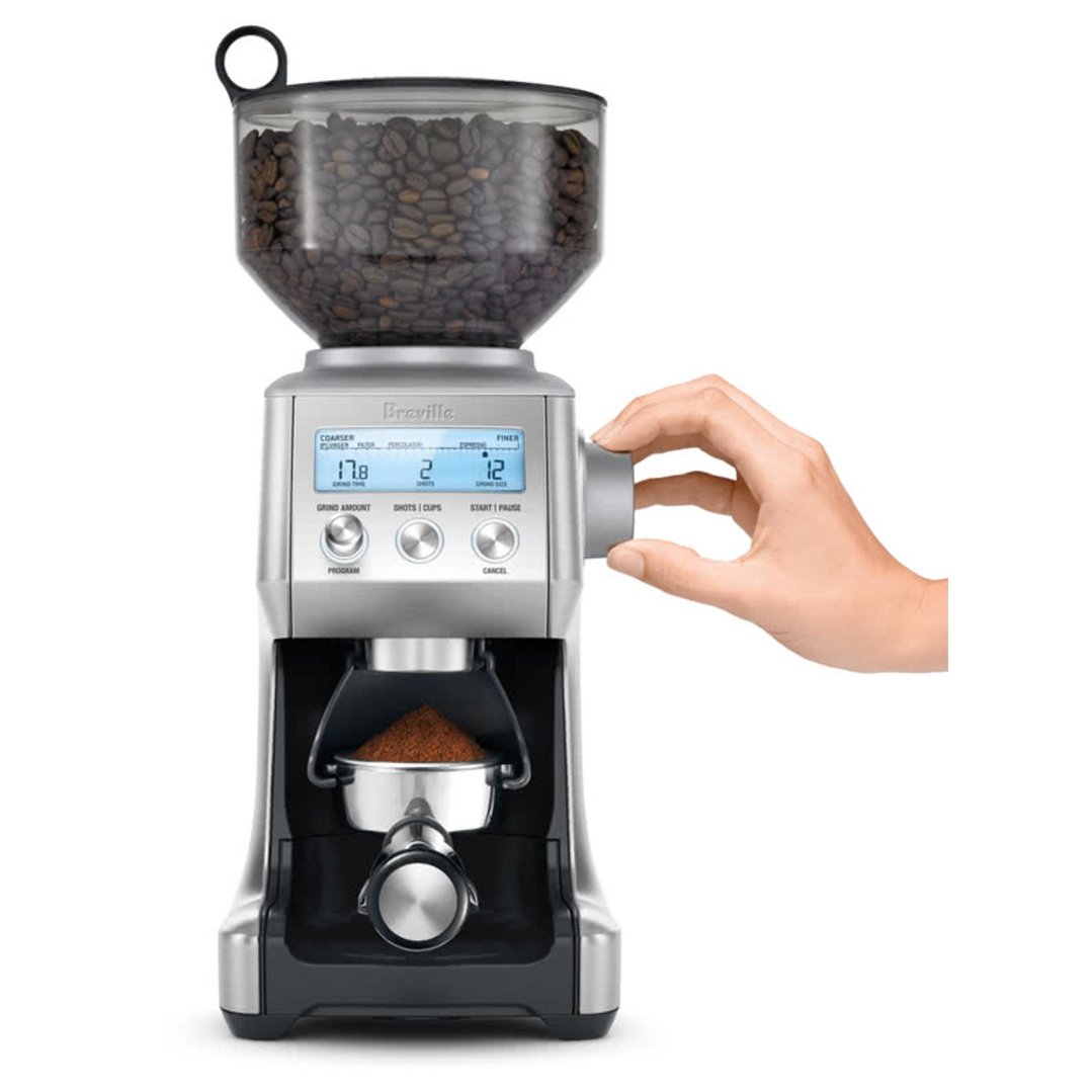 Hand adjusting settings on a Breville Smart Grinder Pro coffee grinder