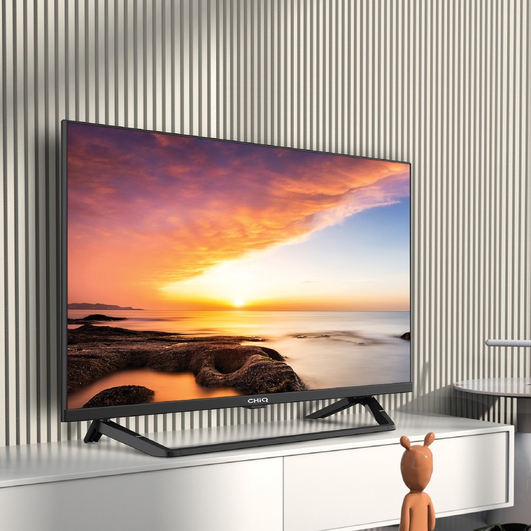 CHIQ TV displaying a sunset scene, on a white cabinet