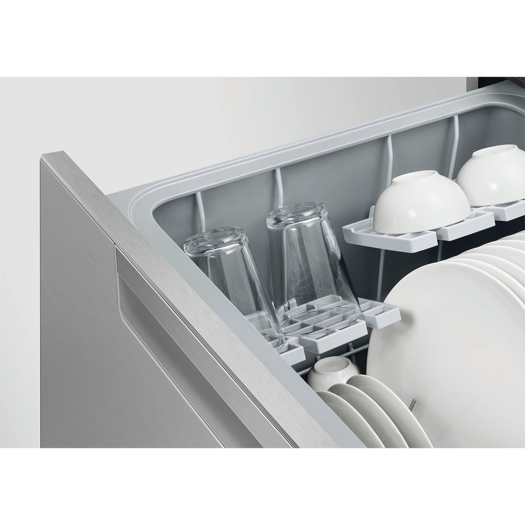 DishDrawer dishwasher with dishes and glasses inside, seen from an angle