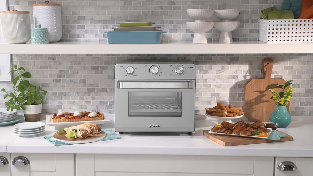 Multi Function Oven + Air Fryer on a kitchen counter with food and decor