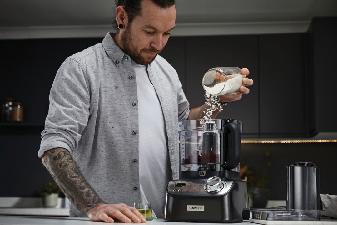 Man pouring flour into a KENWOOD MultiPro XL Weigh+ Food Processor