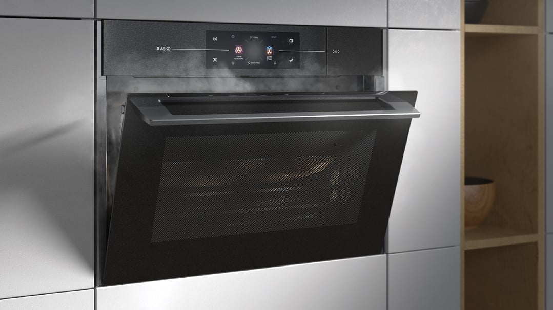Built-in compact combi-microwave-steam oven with door ajar in a modern kitchen