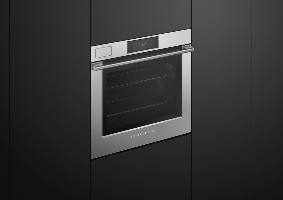 Stainless steel Fisher & Paykel oven built into dark cabinetry